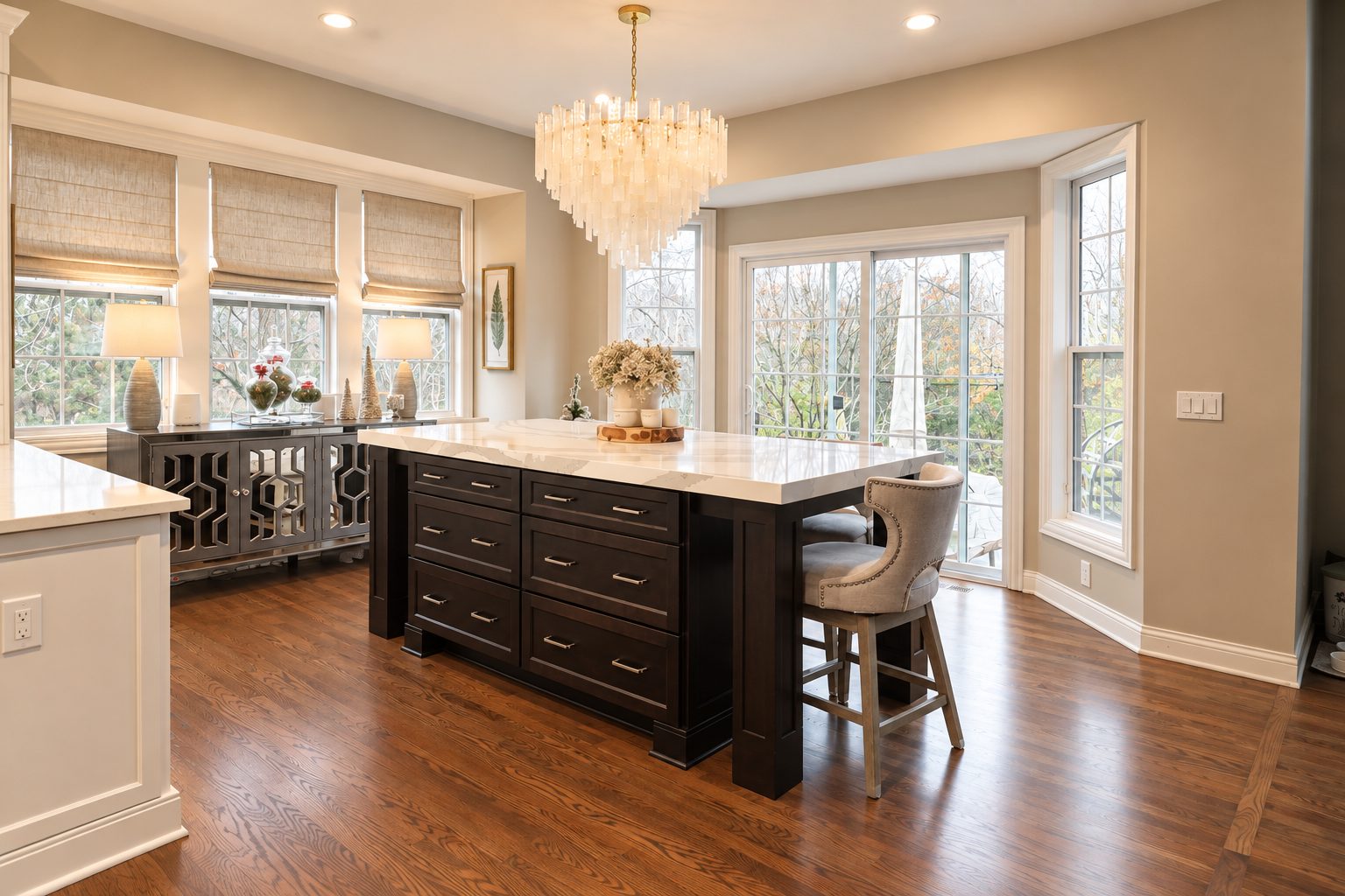 Adjoining breakfast area with dark wood island and chandelier