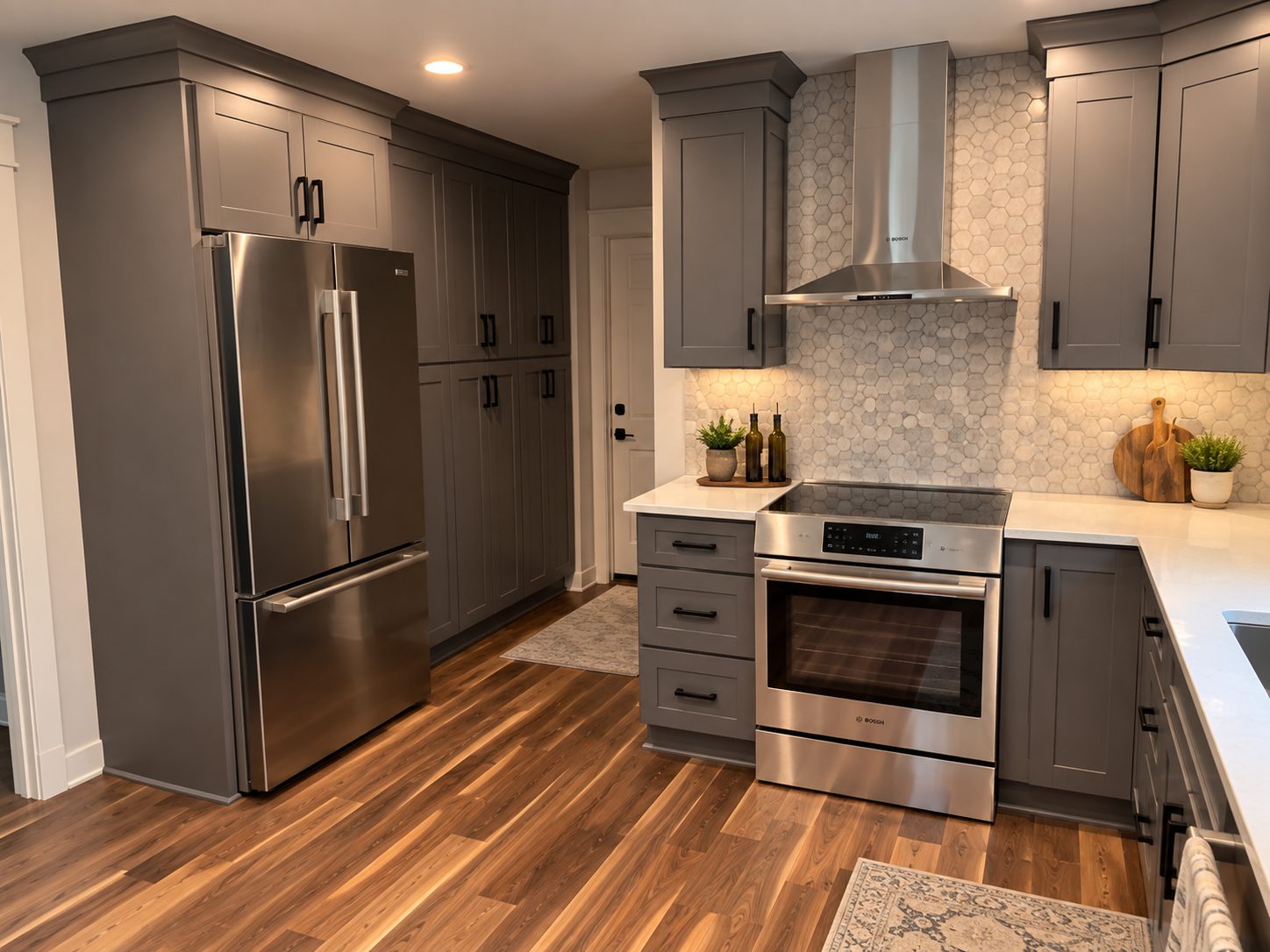 Gray kitchen with stainless refrigerator and hexagon tile backsplash