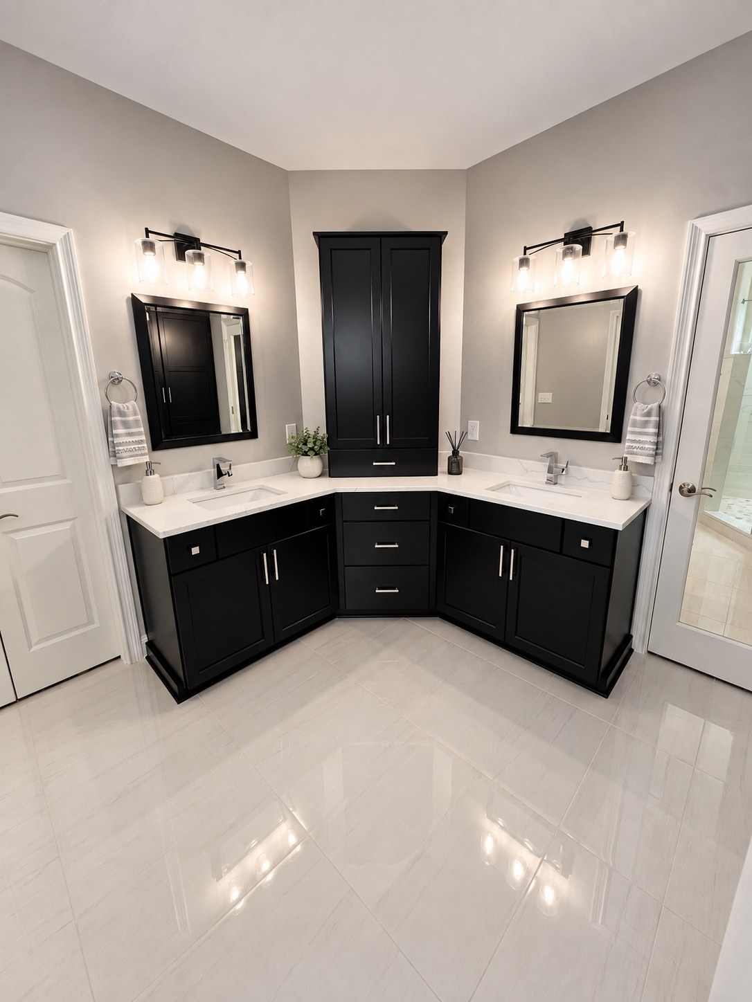 Double vanity with black cabinetry and center storage tower