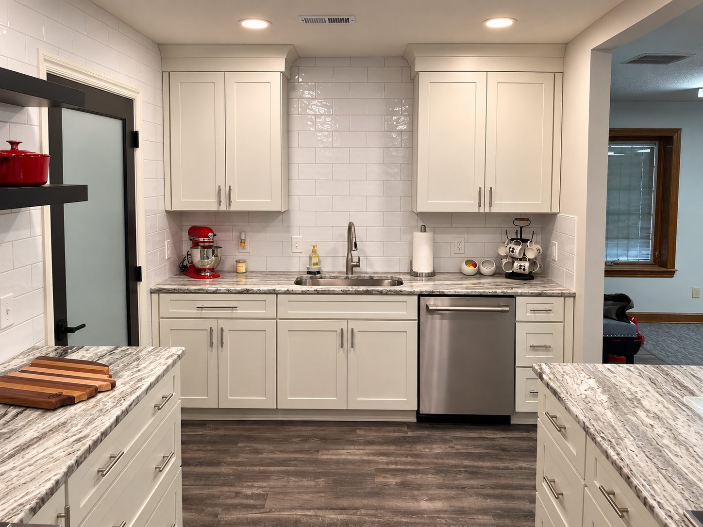 White farmhouse kitchen sink wall with subway tile and stainless dishwasher