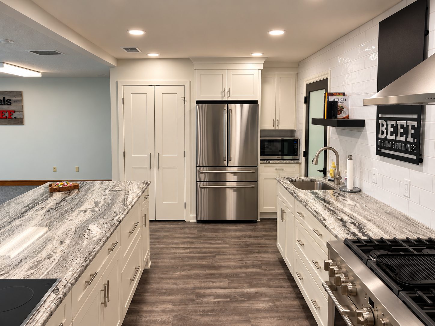 White farmhouse kitchen with stainless French door refrigerator and range